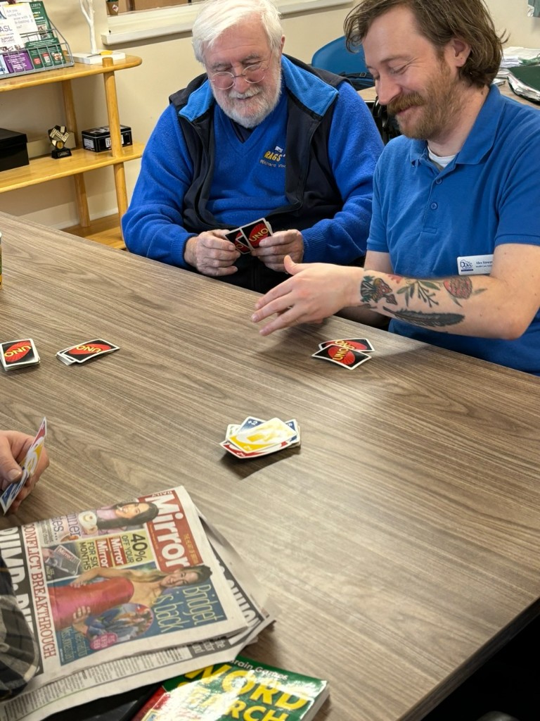 Men playing cards together in the Men's Shed support group