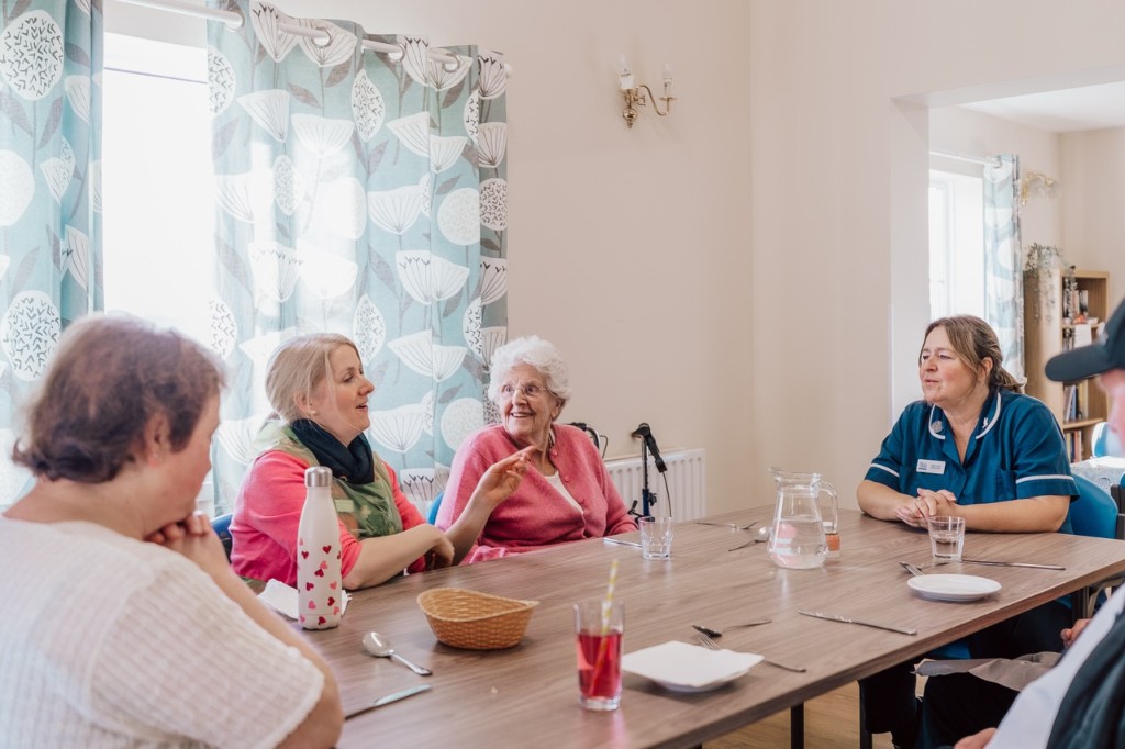 People meeting in a friendly support group session at Dove Cottage
