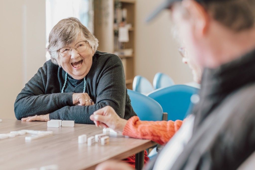 Two people chatting and laughing during a support group activity