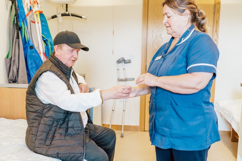 A nurse supporting a patient during a care session