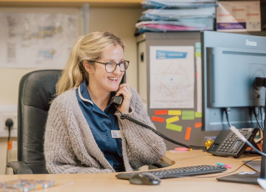 Dove Cottage team member smiling while answering a referral call