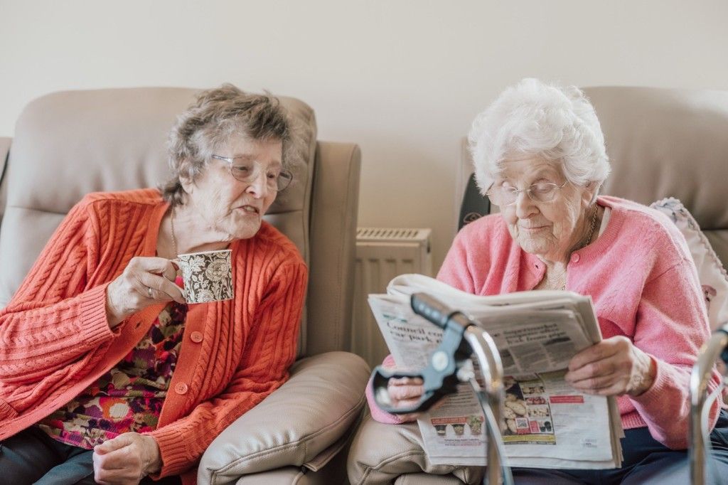 Two people sharing a warm conversation during a dementia support visit